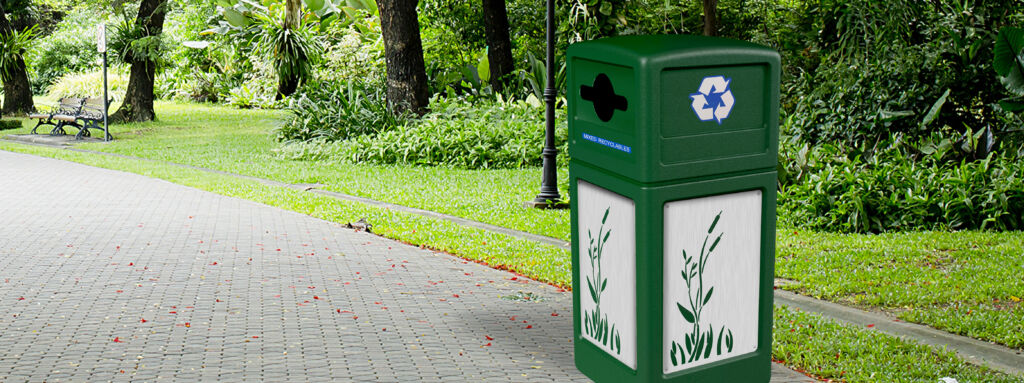 a green Commercial Zone trash receptacle located in a park