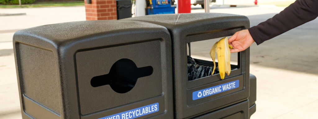 Banana peel being placed in a compost trash container