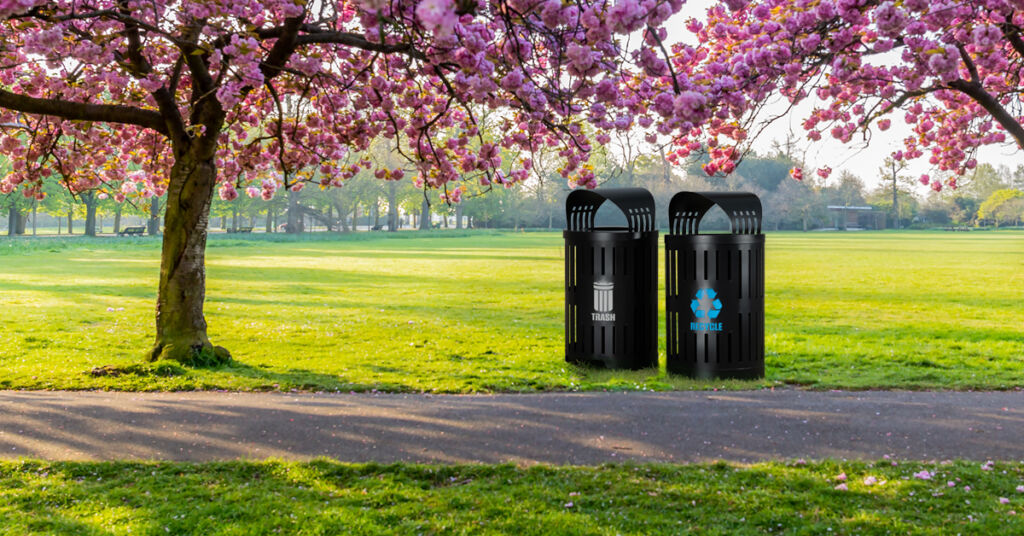 trash and recycling receptacles outdoors in a park